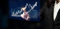 Business professional analyzing financial data trends using digital touchscreen technology with rising graphs and charts Royalty Free Stock Photo