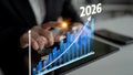 Business professional analyzing financial growth chart on tablet device with projected data from 2023 to 2026 Royalty Free Stock Photo