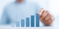 Business professional analyzing growth chart with increasing bars representing success and progress in financial Royalty Free Stock Photo