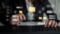 Business professional analyzing data flow with digital interface displaying charts and folders on keyboard in modern Royalty Free Stock Photo