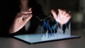Business professional analyzing financial data with virtual interface and graphs on digital tablet in dark environment Royalty Free Stock Photo