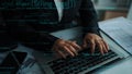 Business professional typing on laptop with programming code overlay in office setting, showcasing technology Royalty Free Stock Photo
