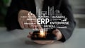 Business Professional Engaging with Smartphone Displaying ERP System and Various Business Terms in a Modern Office Royalty Free Stock Photo