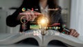 Business professional generating innovative ideas with light bulb above open book and data visualization graphics in Royalty Free Stock Photo