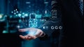 Business Professional Holding Data Security Icon with Digital Elements in a Modern Office Environment at Night. Qubit Royalty Free Stock Photo