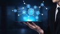 Business professional holding tablet with digital interface displaying connected icons representing technology, data Royalty Free Stock Photo