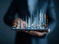 Business professional holding tablet displaying digital data visualization with glowing graphs and charts, representing Royalty Free Stock Photo