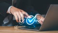 business professional interacting with digital check marks and quality icons, symbolizing online verification, approval processes Royalty Free Stock Photo