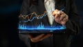 Business professional interacting with digital data analysis on tablet showcasing financial market trends and graphs Royalty Free Stock Photo