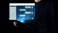 Business professional interacting with an innovative artificial intelligence chat interface while holding a digital Royalty Free Stock Photo