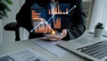 Business professional using smartphone to analyze financial data with graphs and charts in modern office setting Royalty Free Stock Photo