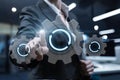 Business professional interacts with virtual gears in modern office Royalty Free Stock Photo