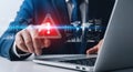Business professional pointing at digital alert on screen highlighting cybersecurity threats and network security Royalty Free Stock Photo