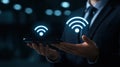 A business professional presents a glowing wireless connectivity symbol with open hands, emphasizing the importance of technology Royalty Free Stock Photo