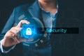 Business professional touching a glowing holographic shield with a lock icon, symbolizing cybersecurity, data protection, secure Royalty Free Stock Photo