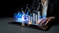 Business professional analyzing financial data on a digital tablet with graphical charts and data visualization in a Royalty Free Stock Photo