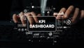 Business Professional Using KPI Dashboard for Data Analysis and Performance Metrics Visualization in Modern Office Royalty Free Stock Photo