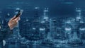 Business professional using smartphone in modern cityscape with digital data overlay showcasing technology and Royalty Free Stock Photo