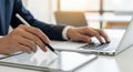Business professional using stylus on tablet and typing on laptop for digital work and data analysis Royalty Free Stock Photo