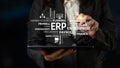 Business Professional Using Tablet to Illustrate Concepts of Enterprise Resource Planning and Management Solutions in a Royalty Free Stock Photo