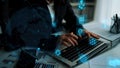 Business Professional Working on Laptop with Global Connectivity and Data Visualization Icons in Modern Office Royalty Free Stock Photo