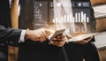 Business professionals analyzing data and financial graphs on smartphone and tablet in a modern office setting Impute Royalty Free Stock Photo