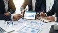 Business professionals analyzing data on a tablet in a meeting Royalty Free Stock Photo