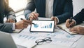 Business professionals analyzing data on a tablet in a meeting Royalty Free Stock Photo