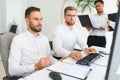 Business professionals. Group of young confident business people analyzing data using computer while spending time in Royalty Free Stock Photo