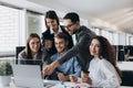 Business professionals. Group of young confident business people analyzing data using computer while spending time in the office Royalty Free Stock Photo