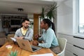 Business professionals. Group of young confident business people analyzing data using computer while spending time in the office. Royalty Free Stock Photo