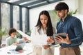 Asian Businesswoman And Arabic Businessman Using Tablet Working In Office Royalty Free Stock Photo