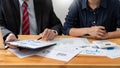 Business professionals sitting around table meeting colleagues working together brainstorming on project discussing and planning Royalty Free Stock Photo