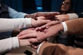 Business professionals stacking hands in support of collaboration, inclusion, and equality in the office. The workplace Royalty Free Stock Photo