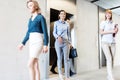 Business professionals walking out of elevator in office Royalty Free Stock Photo