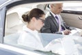 Business professionals working on laptop and documents car Royalty Free Stock Photo