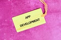 Business, programming, interface, application and network concept. Text APP DEVELOPMENT on the card on a crimson Royalty Free Stock Photo