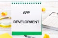 Business, programming, interface, application and network concept. Text APP DEVELOPMENT in an upright notebook Royalty Free Stock Photo