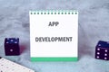 Business, programming, interface, application and network concept. Text APP DEVELOPMENT on an upright notepad Royalty Free Stock Photo