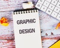 Business, programming, interface, application and network concept. Text GRAPHIC DESIGN in a notebook against the Royalty Free Stock Photo
