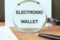 Business, programming, interface, application and network concept. Words ELECTRONIC WALLET on a white sheet through a Royalty Free Stock Photo