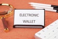 Business, programming, interface, application and network concept. Words ELECTRONIC WALLET written on a business card Royalty Free Stock Photo