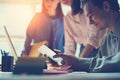 Marketing team discussing new working plan. Laptop and paperwork in open space office. Man sitting with tablet PC Royalty Free Stock Photo