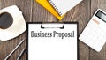 BUSINESS PROPOSAL text on paper with coffee, calculator and notebook. Business concept Royalty Free Stock Photo