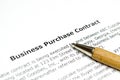 Business purchase contract with wooden pen Royalty Free Stock Photo