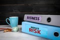 BUSINESS and REDUCE RISK concept. Documents on a wooden office desk Royalty Free Stock Photo