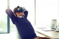 Business and relaxation done in one. a businessman wearing a VR headset while leaning back in his office chair at work. Royalty Free Stock Photo