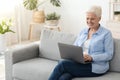 Business After Retirement. Smiling Senior Woman Working On Laptop Computer At Home Royalty Free Stock Photo