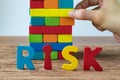business risk concept with hand pulling colorful wooden block to Royalty Free Stock Photo