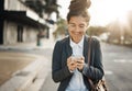 Business, road and woman with a cellphone, typing and travel with internet connection, mobile app and smile. Female